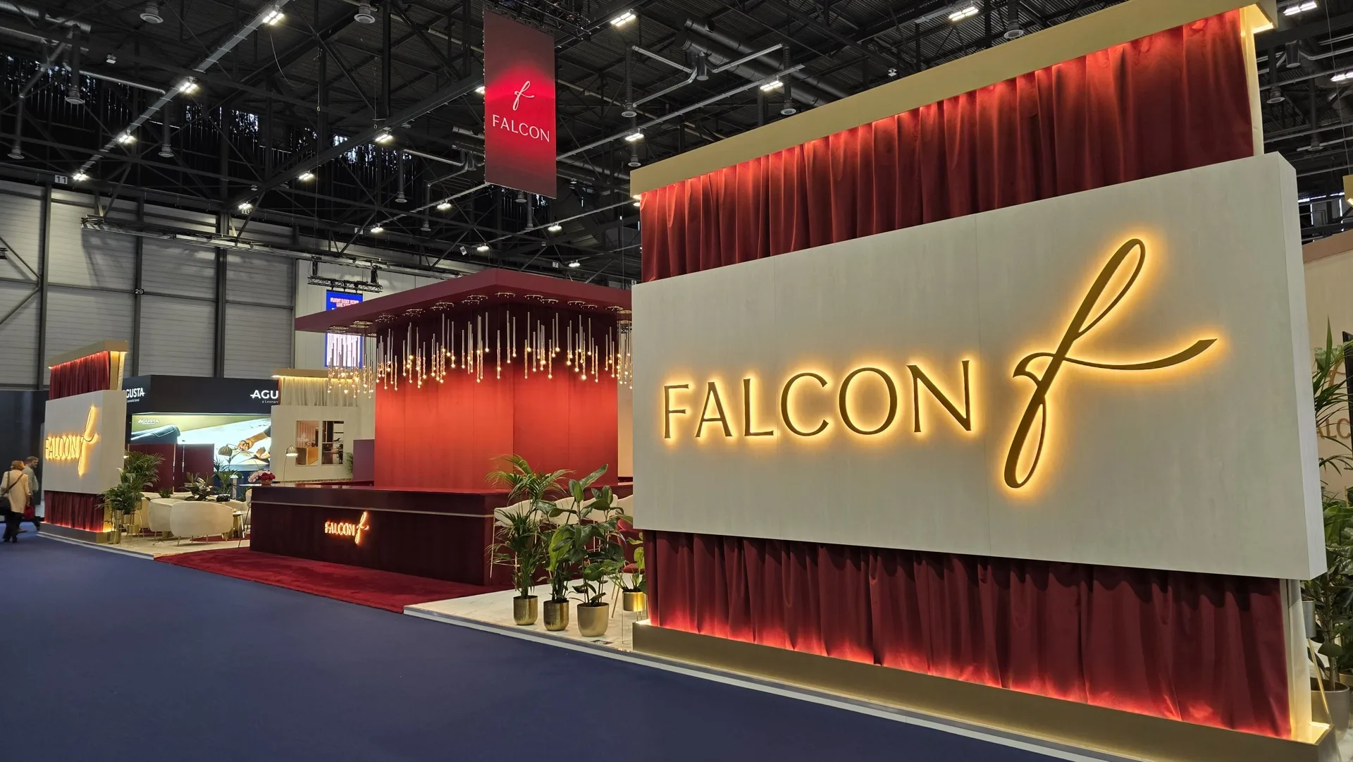 Falcon stand exterior with back-lit logo and chandelier bar